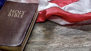 Image of a Bible and an American flag.